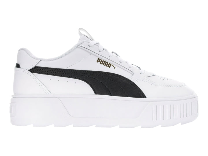 Tenis PUMA blancos con franja negra lateral y suela de plataforma blanca.