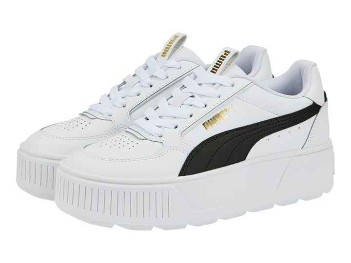 Tenis PUMA blancos con franja negra lateral y suela de plataforma blanca.