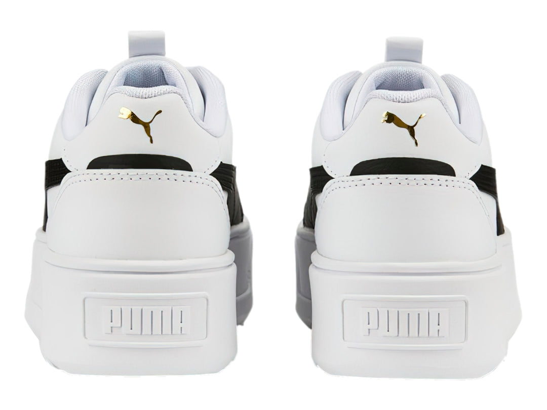 Tenis PUMA blancos con franja negra lateral y suela de plataforma blanca.