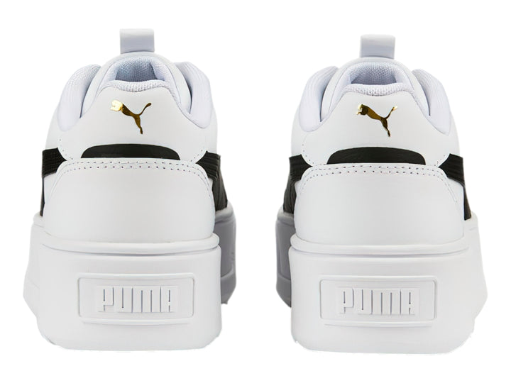 Tenis PUMA blancos con franja negra lateral y suela de plataforma blanca.