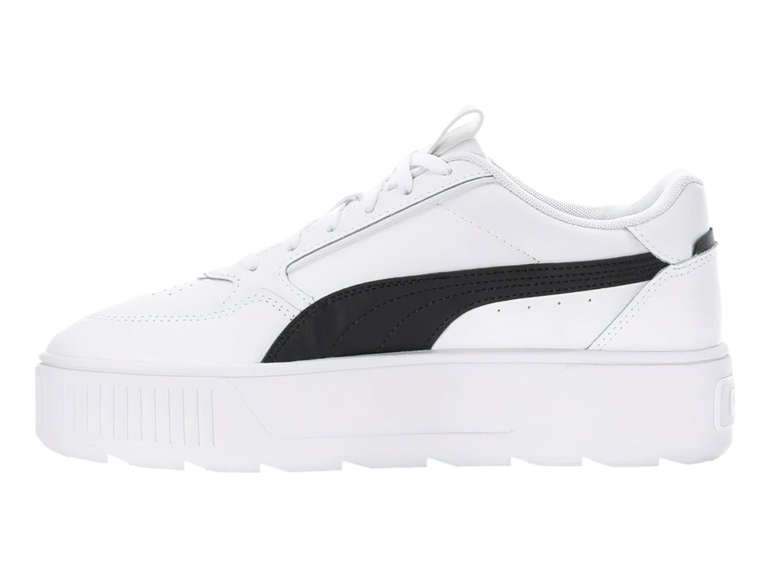 Tenis PUMA blancos con franja negra lateral y suela de plataforma blanca.