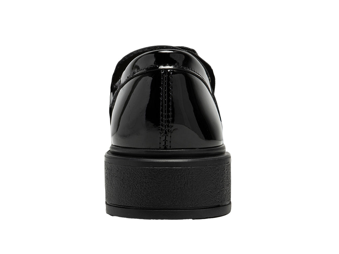 Zapato infantil de charol negro brillante con moño decorativo y suela gruesa.