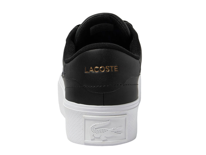 Tenis Lacoste Ziane Platform en color negro con suela blanca ancha y logo dorado lateral.