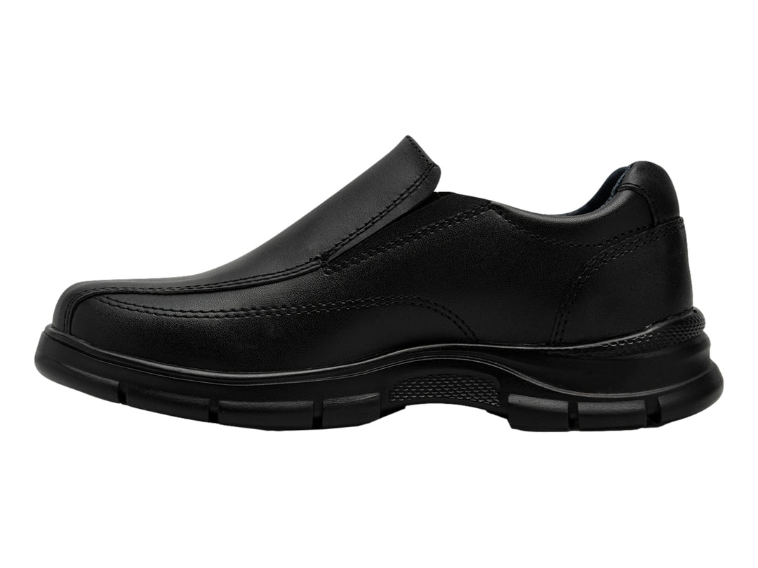 Zapato negro estilo slip-on para niño, material sintético y suela gruesa.