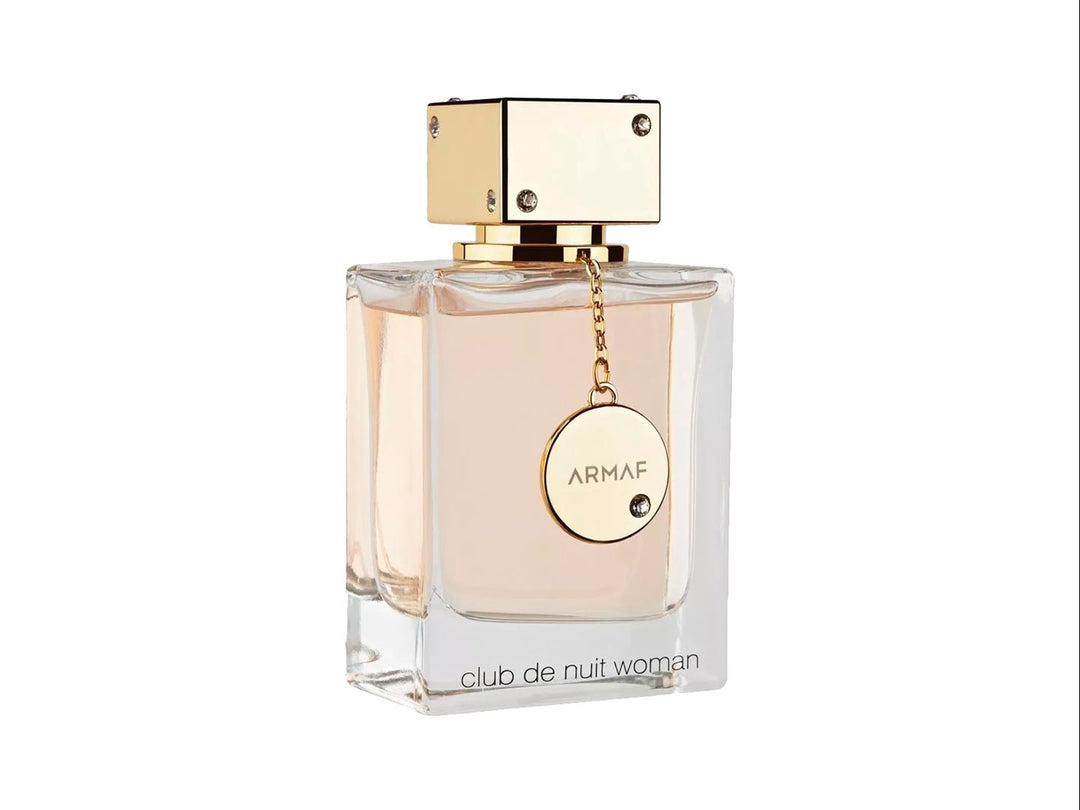 Perfume Armaf Club de Nuit Woman en botella de vidrio transparente con tapa dorada y su caja color rosa.