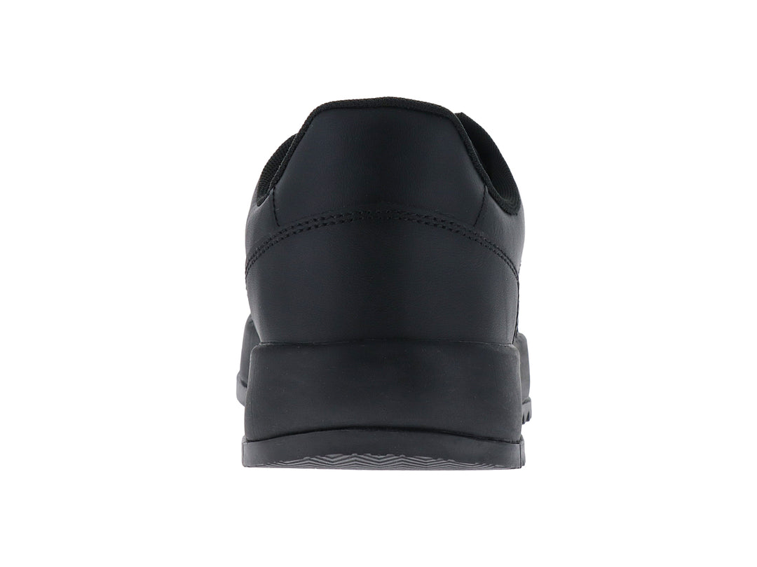 Tenis negros Tommy Jeans de corte bajo con suela gruesa y logo lateral.