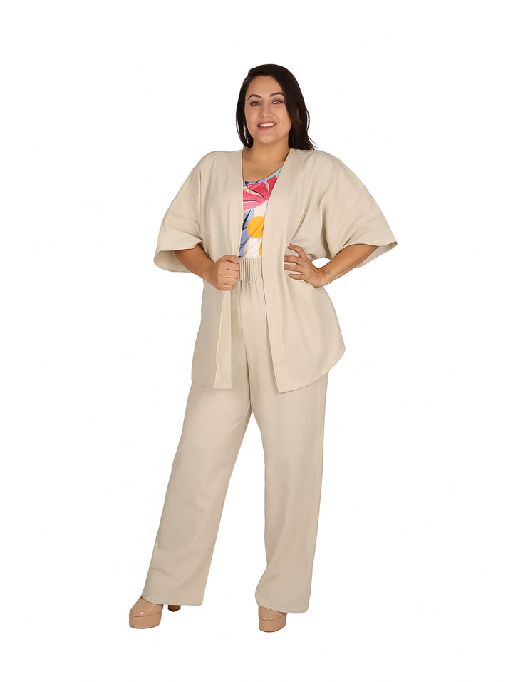 Mujer vistiendo conjunto de lino color arena compuesto por pantalón ancho y ensamble abierto.