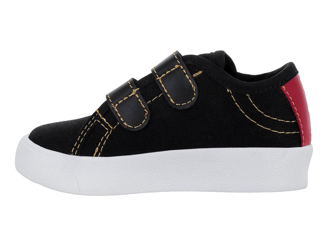 Zapato casual negro para niño con suela blanca y cierre de dos correas de velcro.