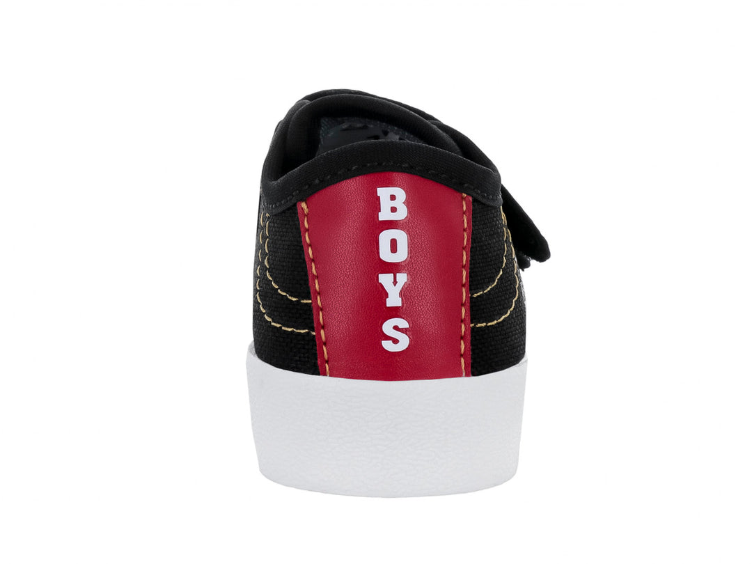 Zapato infantil color negro con suela blanca y cierre de velcro.