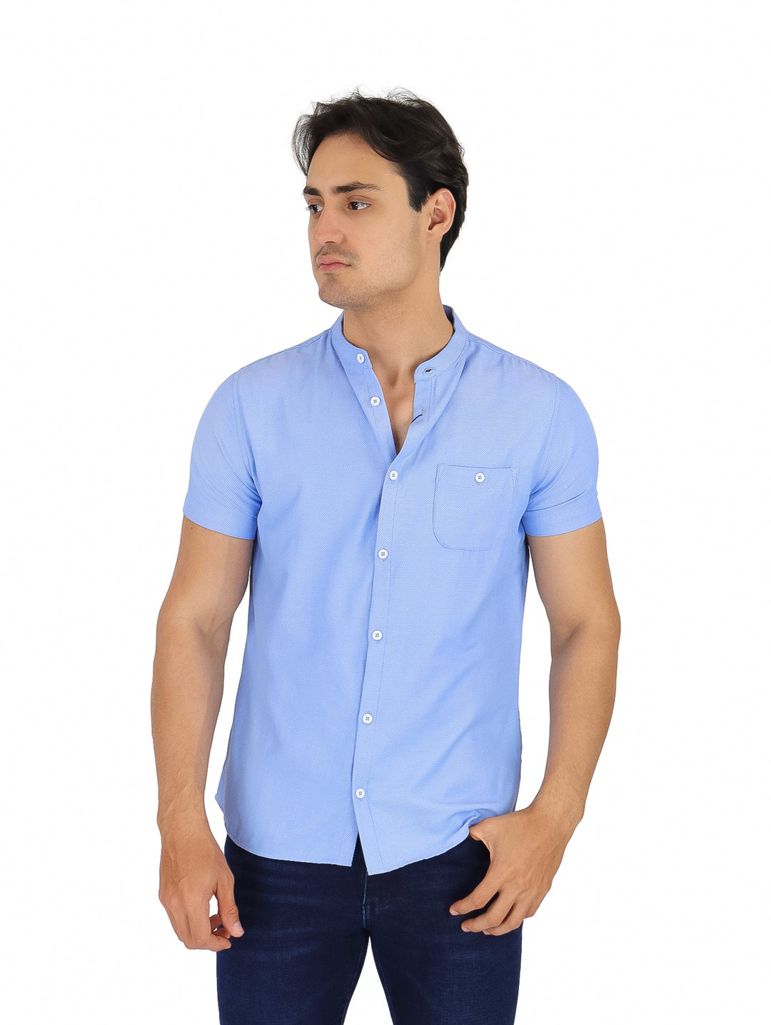 Hombre vistiendo camisa azul claro de manga corta con cuello henley y bolsillo frontal.