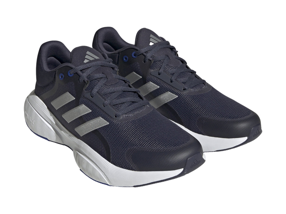 Tenis Adidas Response en color azul marino con franjas plateadas y suela blanca.