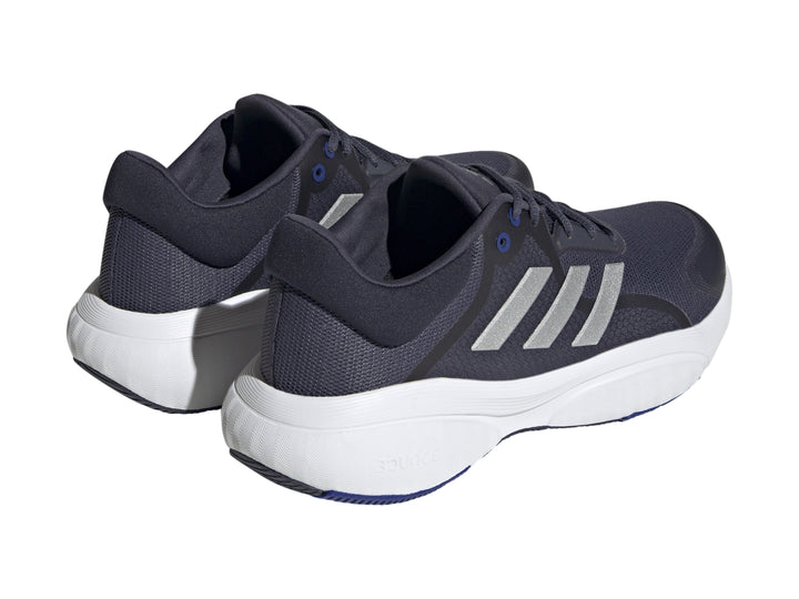 Tenis Adidas Response en color azul marino con franjas plateadas y suela blanca.