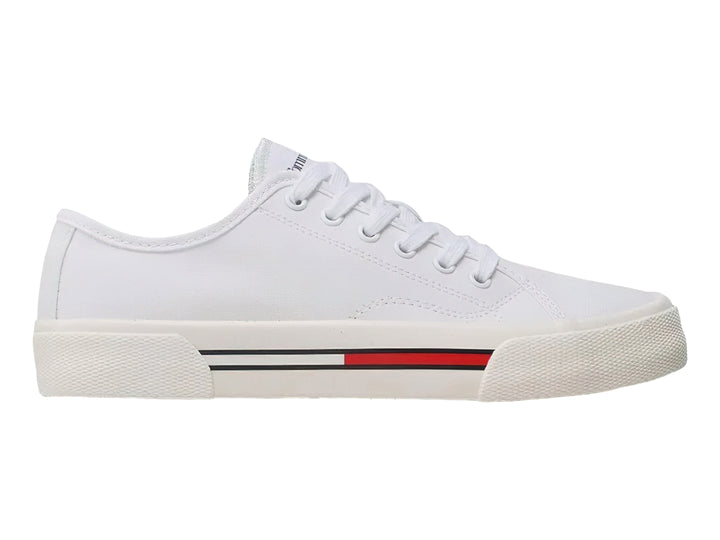 Tenis blancos de lona Tommy Hilfiger para mujer con detalle de franja roja y azul en la suela.