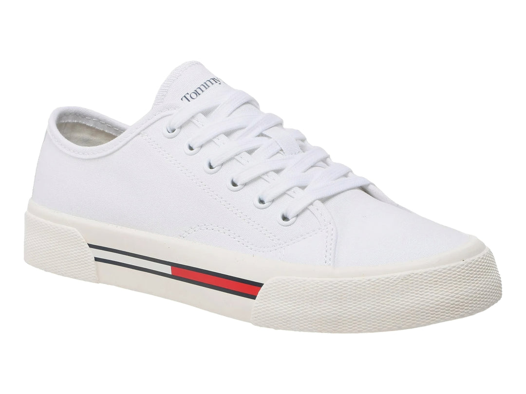 Tenis blancos de lona Tommy Hilfiger para mujer con detalle de franja roja y azul en la suela.