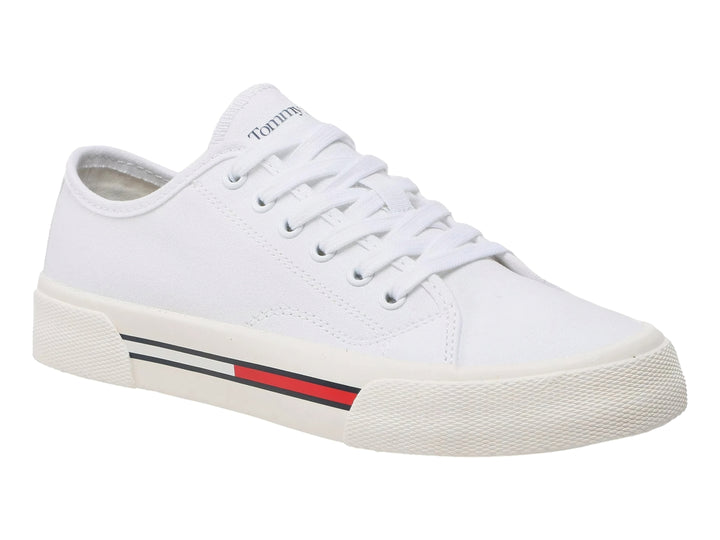 Tenis blancos de lona Tommy Hilfiger para mujer con detalle de franja roja y azul en la suela.