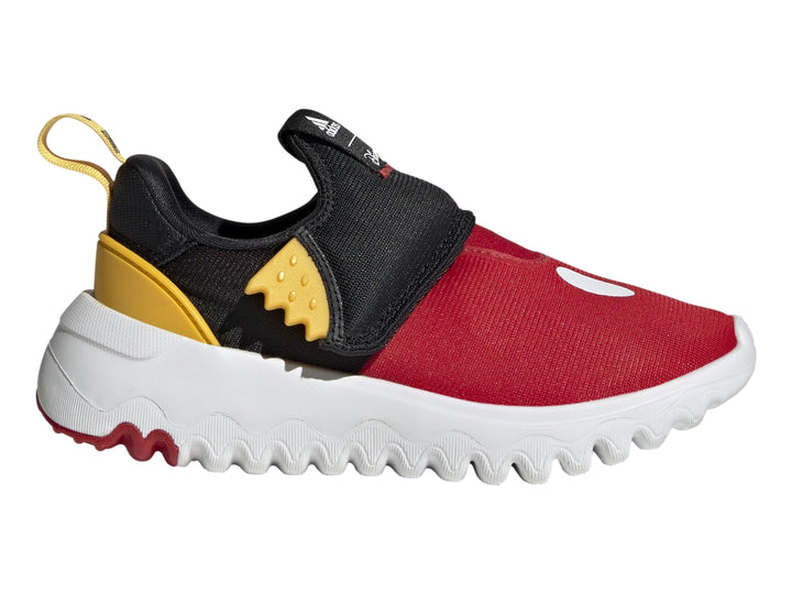 Zapato deportivo Adidas infantil en colores rojo, negro y amarillo con suela blanca ondulada.