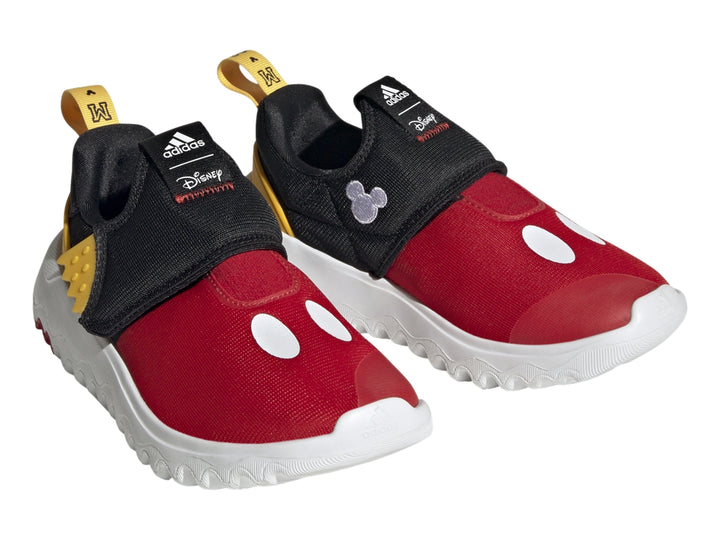 Zapato deportivo Adidas infantil en colores rojo, negro y amarillo con suela blanca ondulada.