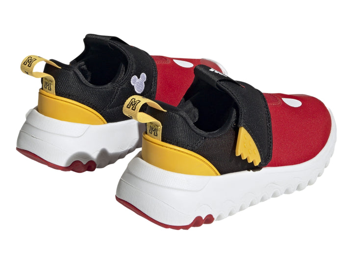Zapato deportivo Adidas infantil en colores rojo, negro y amarillo con suela blanca ondulada.