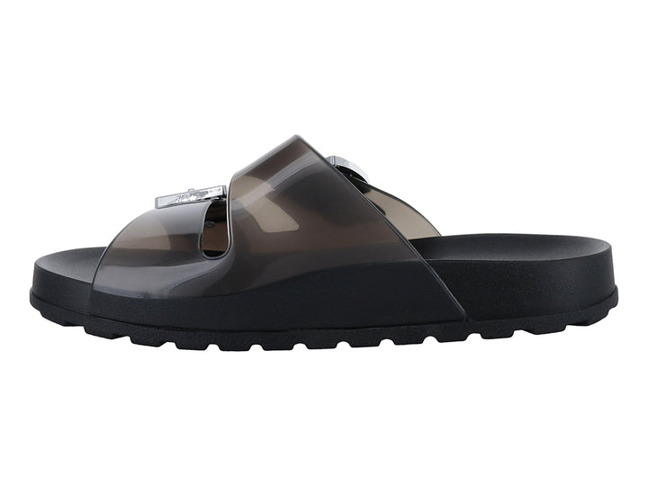 Sandalias negras de plataforma con tiras translúcidas y hebillas plateadas.