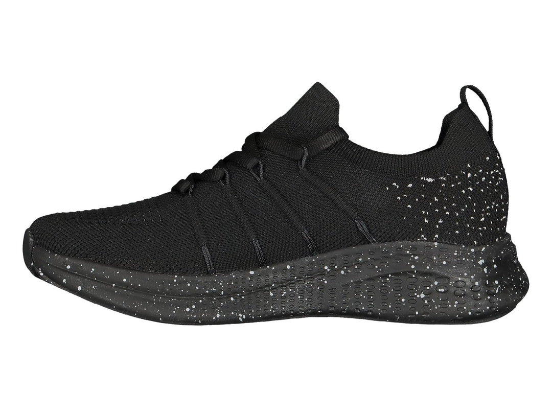 Tenis deportivos color negro con detalles moteados blancos en la suela.