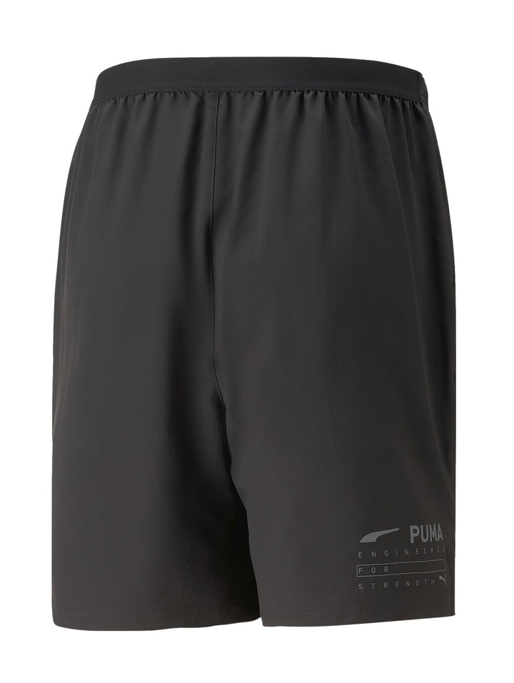 Pantalones cortos deportivos PUMA color negro con logotipo gris en la pierna izquierda y cintura elástica.