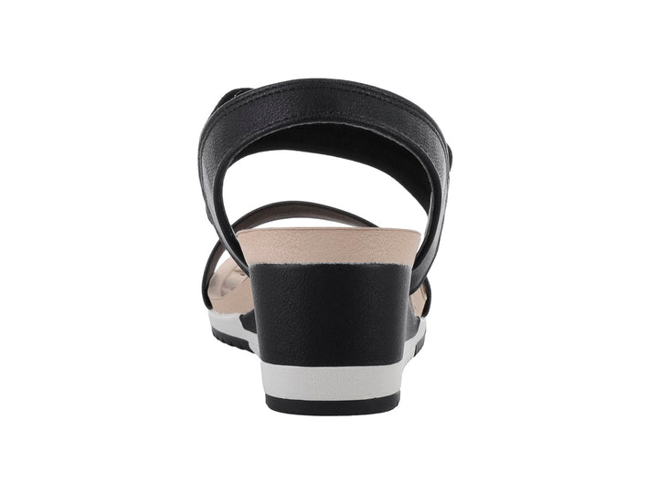 Sandalia Modare de cuña color negro con suela blanca y beige, diseño de correas anchas para mujer.