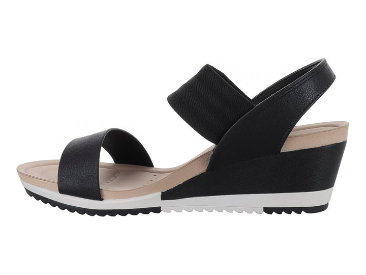 Sandalia Modare de cuña color negro con suela blanca y beige, diseño de correas anchas para mujer.