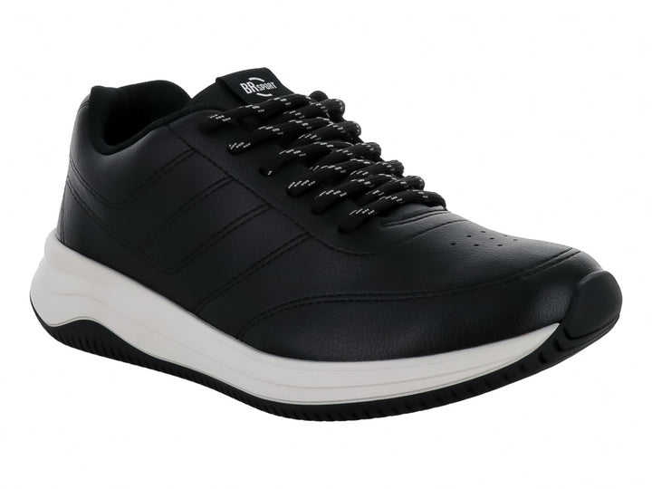 Tenis deportivos color negro con suela blanca y cordones, vista lateral.