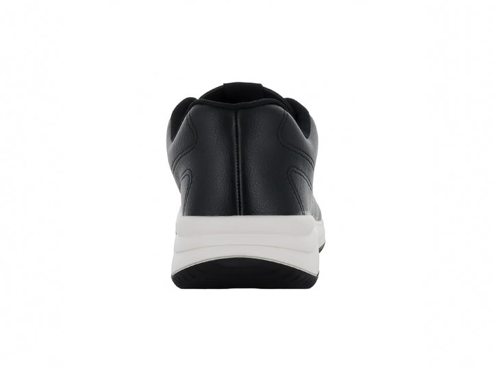 Tenis deportivos color negro con suela blanca y cordones, vista lateral.