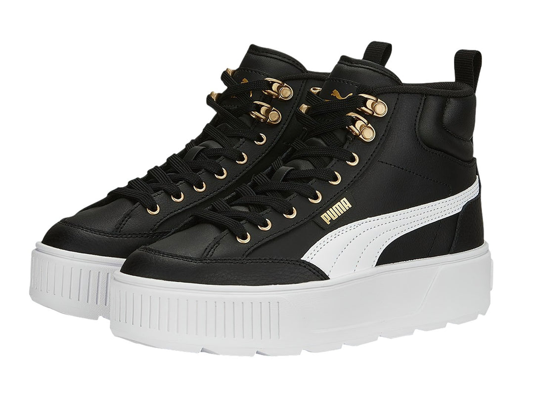 Tenis PUMA Carmen Mid color negro con suela blanca de plataforma y ojillos dorados.