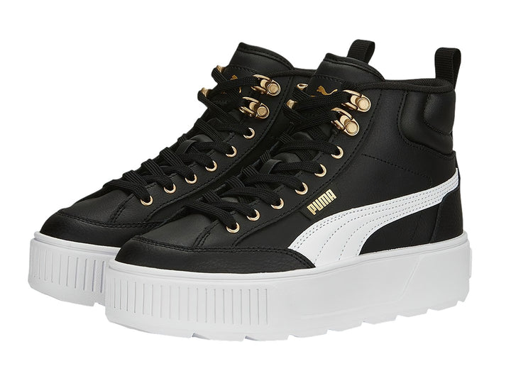 Tenis PUMA Carmen Mid color negro con suela blanca de plataforma y ojillos dorados.