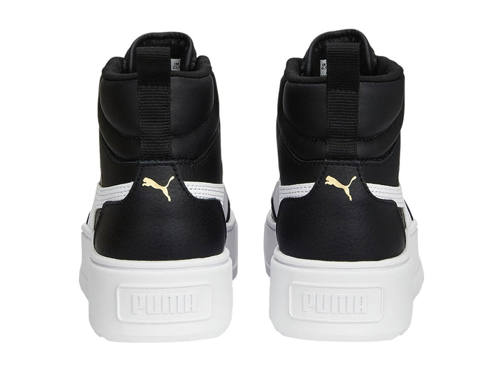 Tenis PUMA Carmen Mid color negro con suela blanca de plataforma y ojillos dorados.