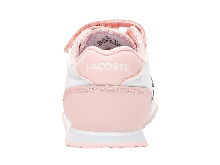 Tenis Lacoste blancos con detalles en rosa y cierres de velcro.