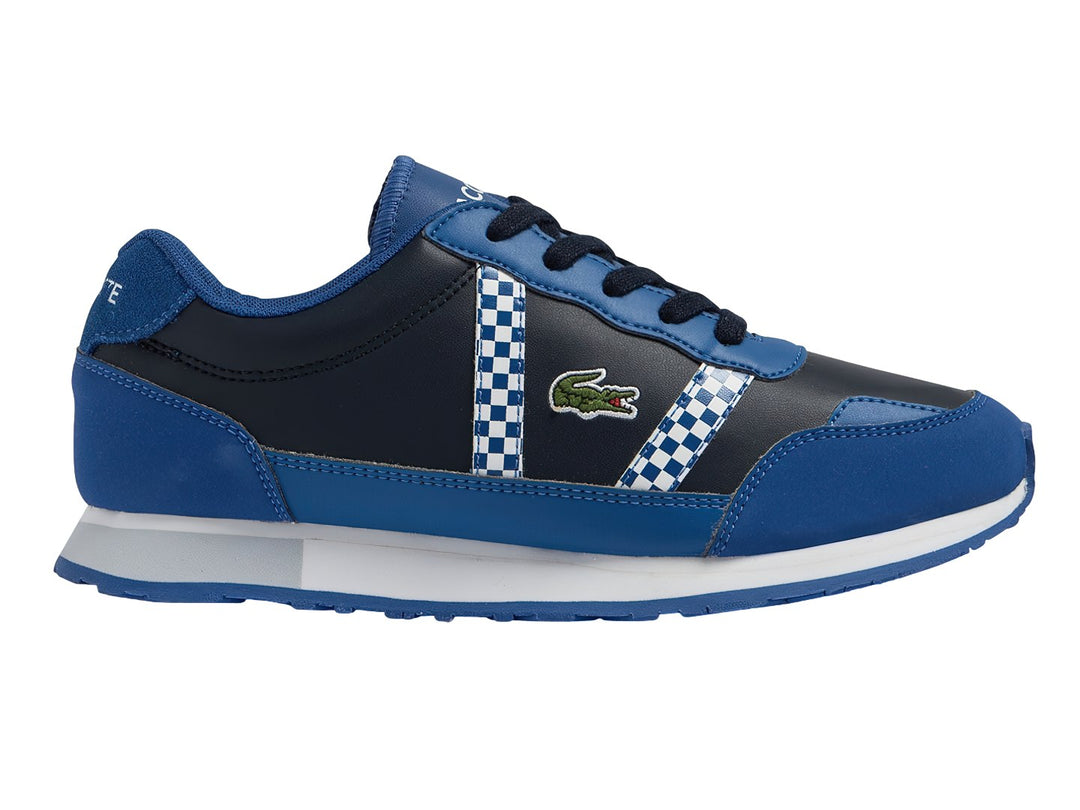 Tenis deportivos Lacoste para niños en azul marino y azul real con detalles de cuadros blancos y suela blanca.