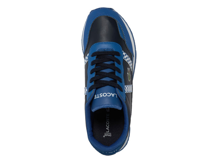 Tenis deportivos Lacoste para niños en azul marino y azul real con detalles de cuadros blancos y suela blanca.