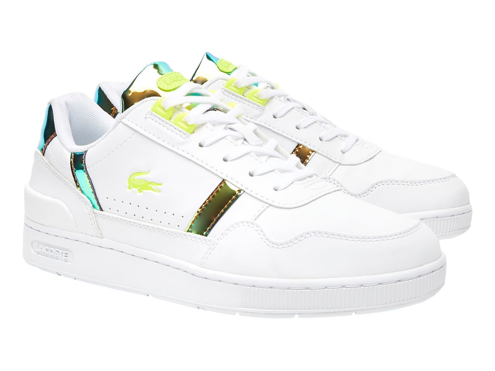 Tenis Lacoste blancos con detalles metálicos dorados y agujetas amarillas.