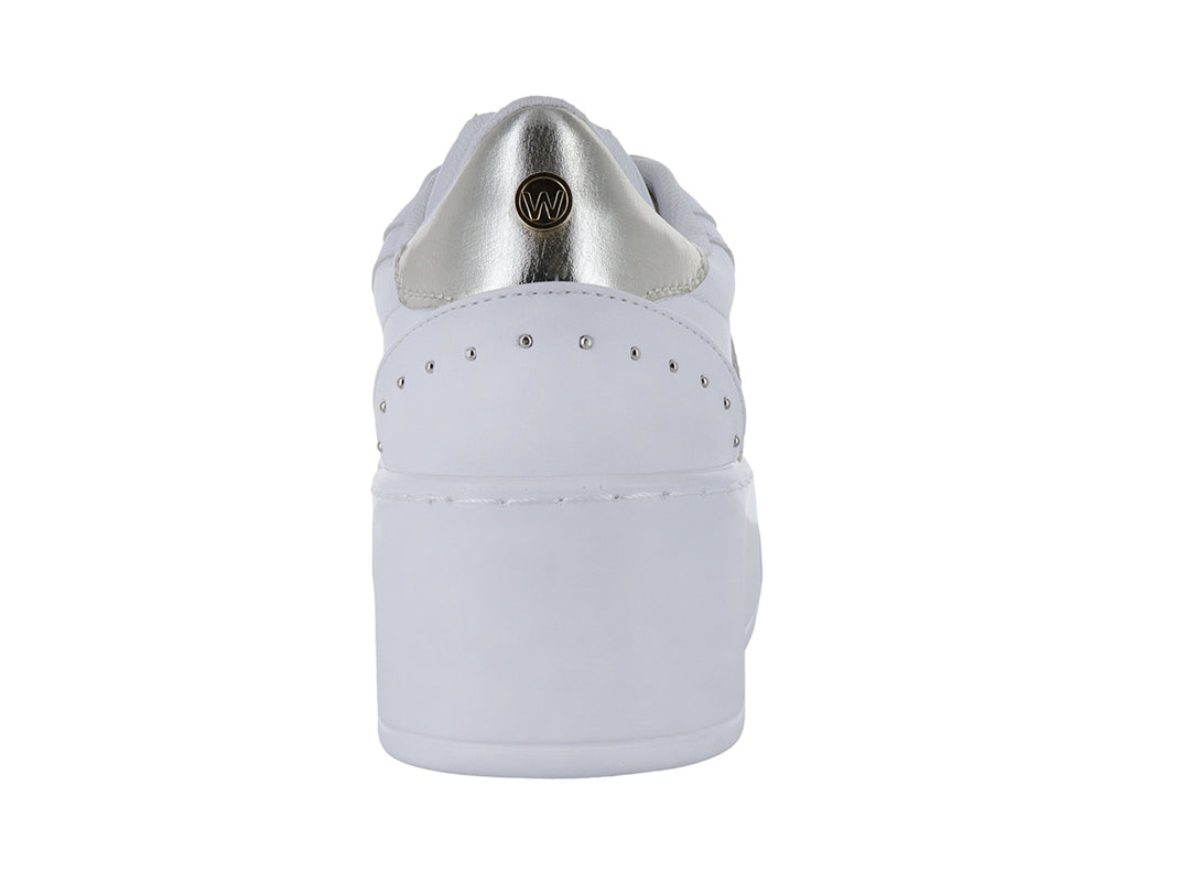 Tenis blancos de plataforma para niña con detalles en color platino y agujetas blancas.