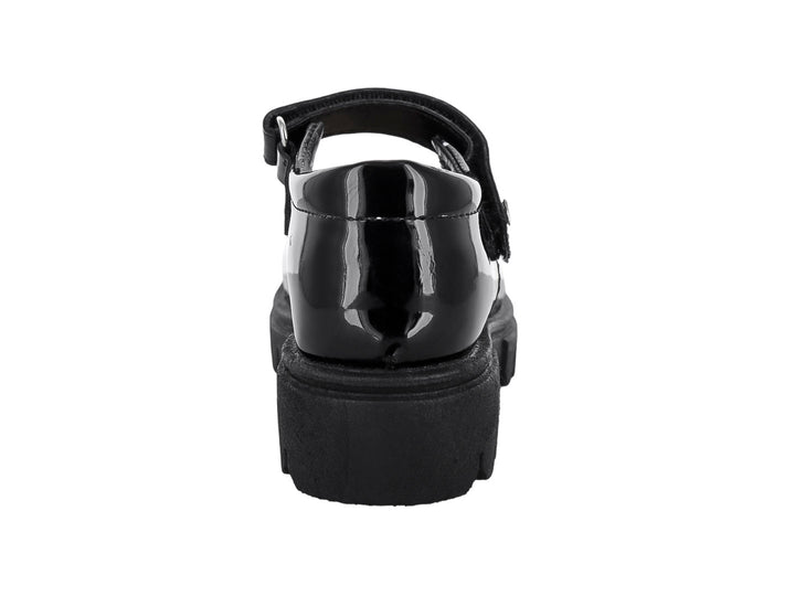 Zapato infantil de charol negro estilo Mary Jane con suela gruesa dentada y correa ajustable.