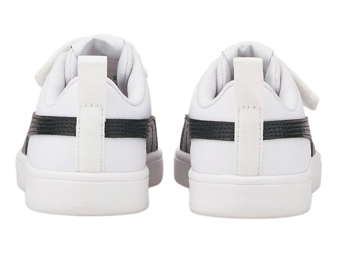 Tenis PUMA blancos para niño con franja negra lateral y correa de velcro.