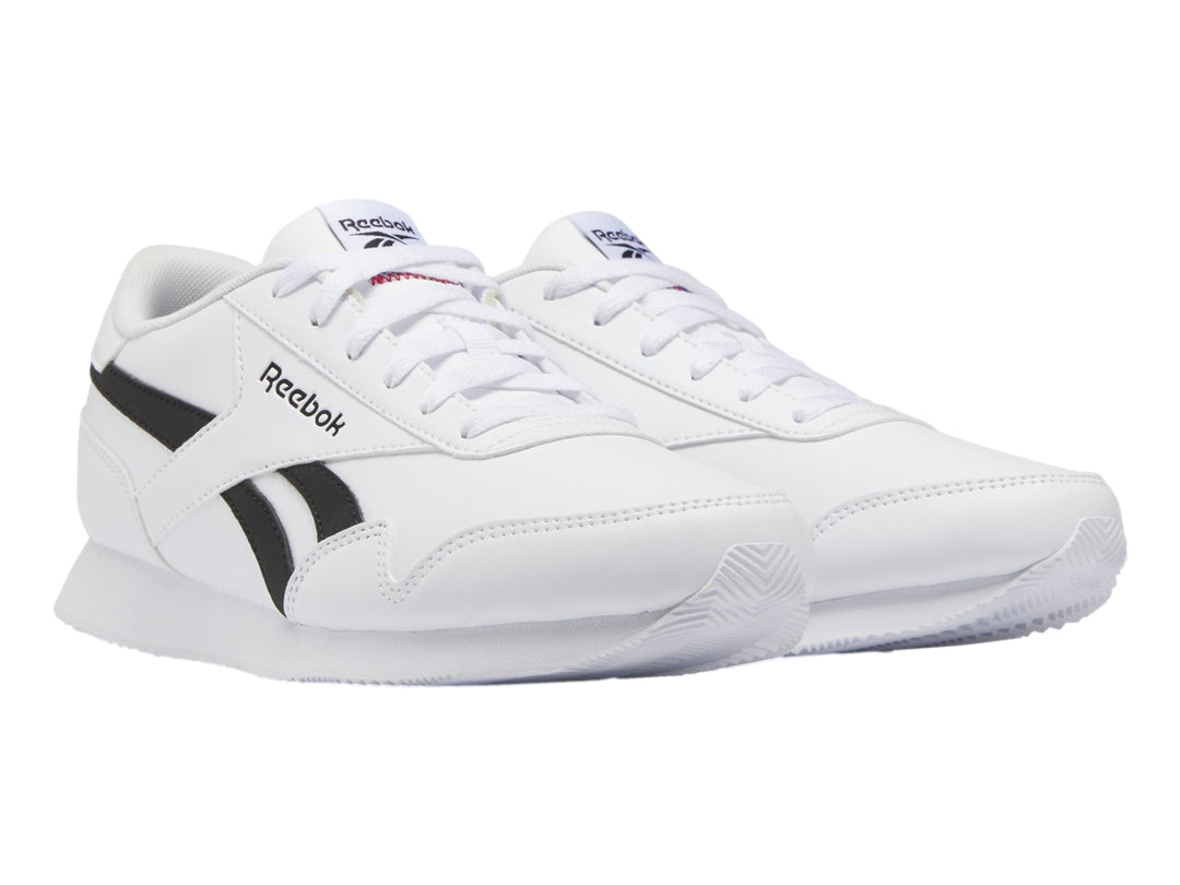 Tenis deportivos Reebok color blanco con franjas negras laterales y suela blanca.