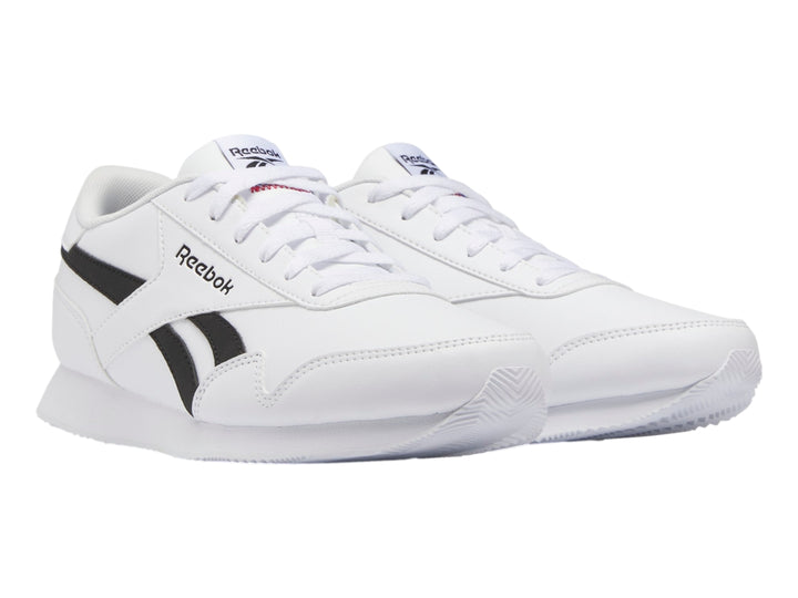 Tenis deportivos Reebok color blanco con franjas negras laterales y suela blanca.