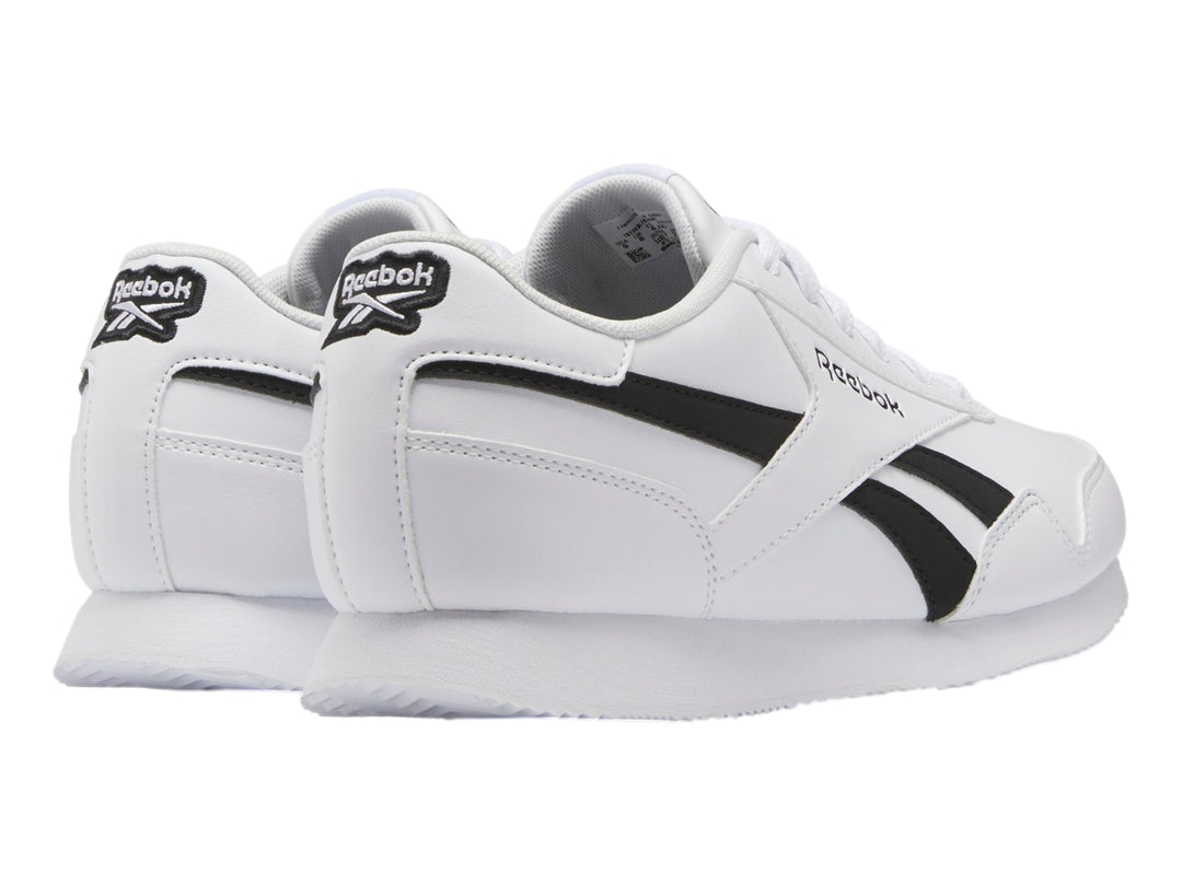 Tenis deportivos Reebok color blanco con franjas negras laterales y suela blanca.