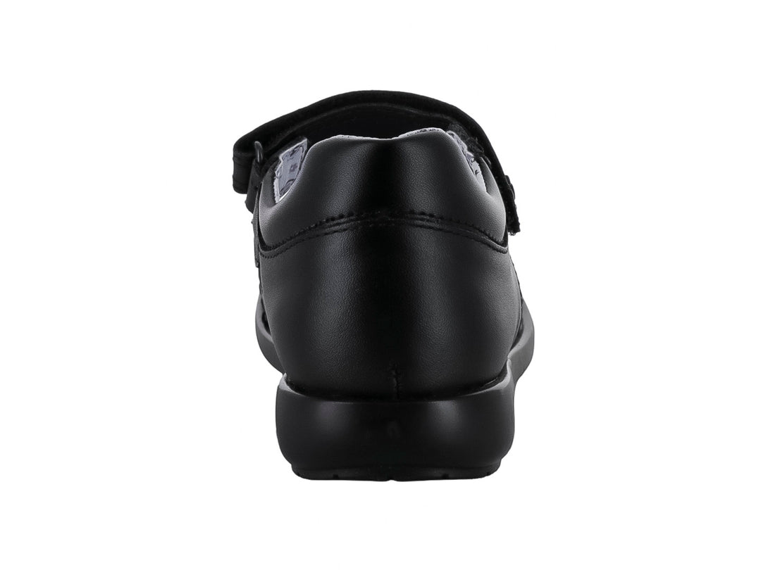 Zapato negro para niña de material sintético con correa de cierre y forro interior estampado de corazones.
