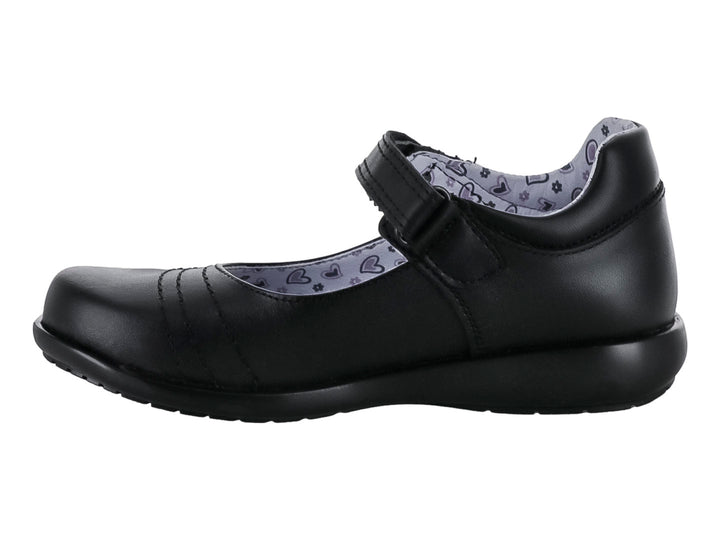 Zapato negro para niña de material sintético con correa de cierre y forro interior estampado de corazones.