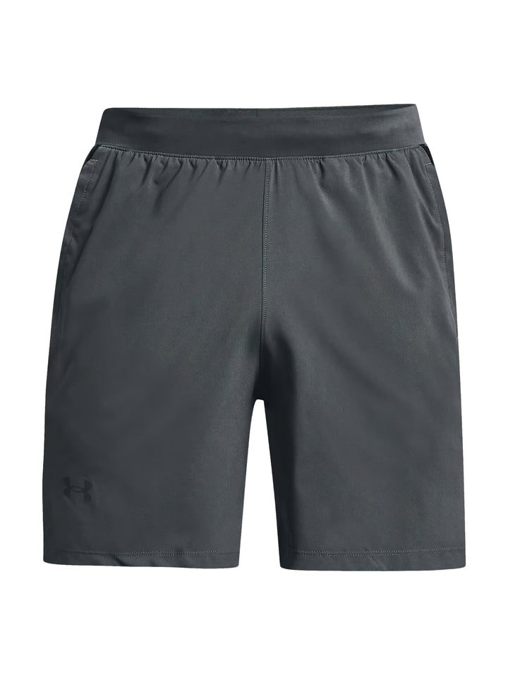 Hombre vistiendo shorts deportivos Under Armour de color gris con corte a 7 pulgadas.