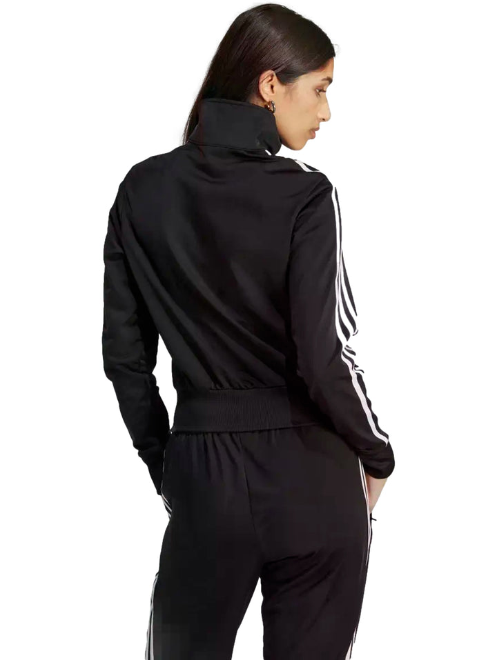 Chamarra deportiva Adidas Adicolor Classics Firebird en color negro con tres franjas blancas en las mangas.