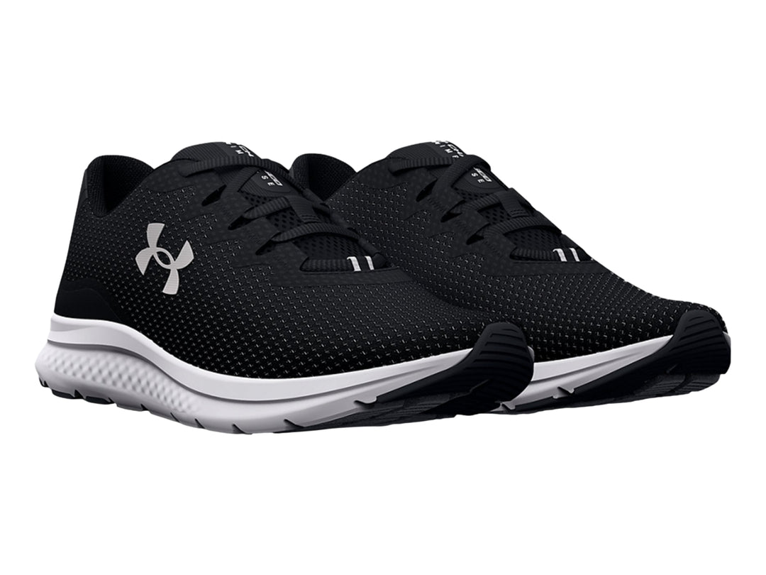 Tenis deportivos Under Armour Charged Impulse 3 en color negro con suela blanca y logo plateado lateral.