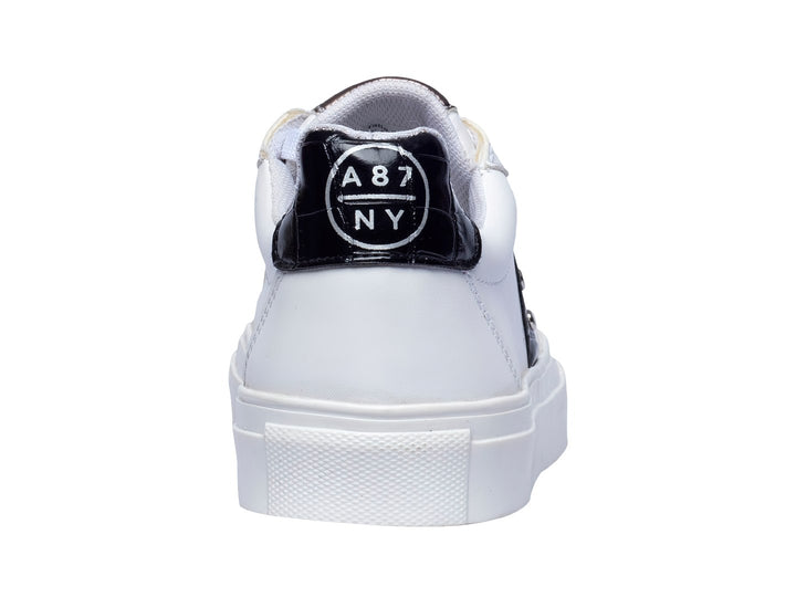 Tenis blancos Aeropostale con franja negra lateral y suela blanca de plataforma.