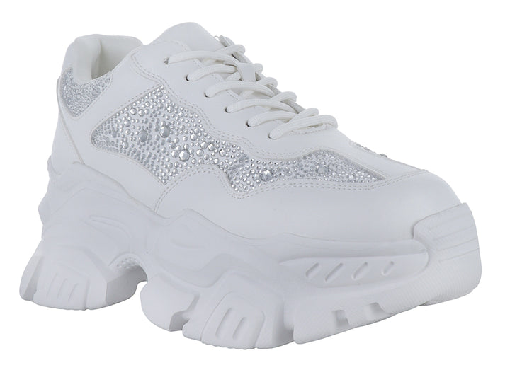 Tenis blancos de plataforma con detalles de pedrería brillante en los laterales.