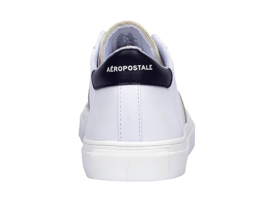 Tenis casuales Aeropostale color blanco con franjas laterales en dorado y gris, suela blanca y detalles negros en el talón.